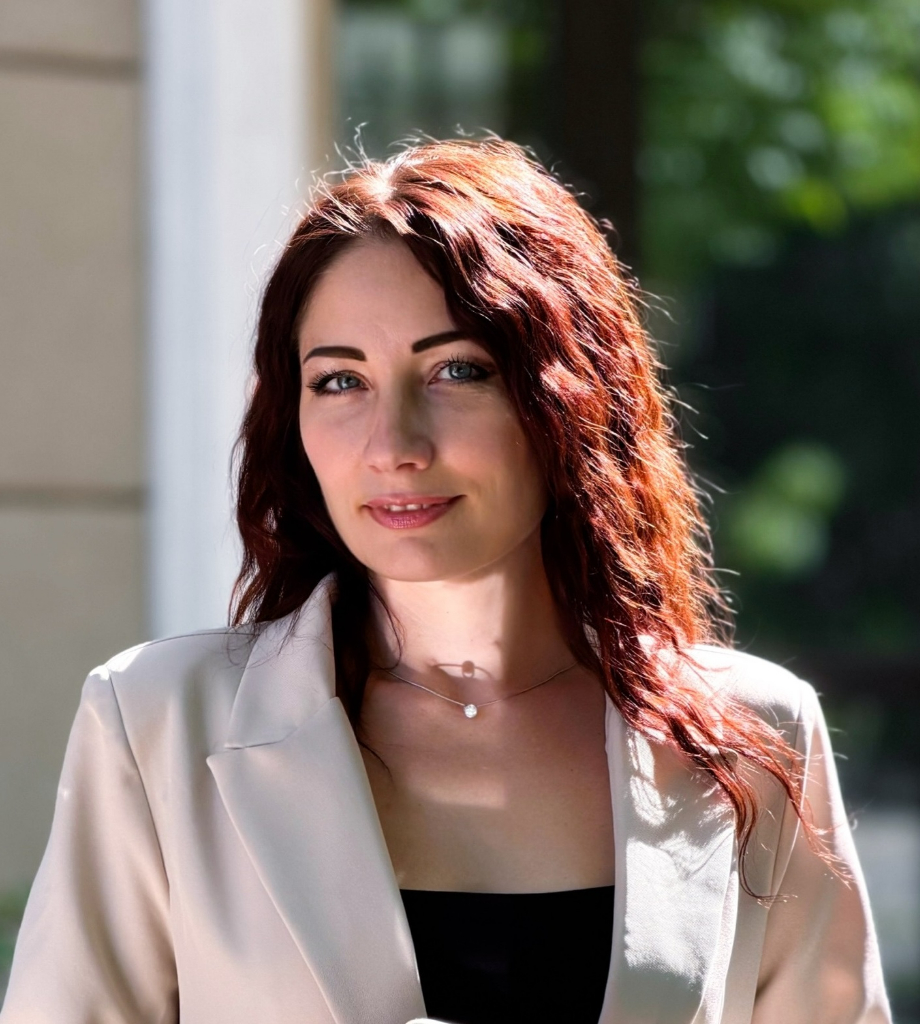 Portrait of Russian female psychologist Irina Voychenko, 36 years old, light hazel-brown eyes, gentle confident smile, fair skin, elegant chestnut hair softly styled, wearing a sophisticated beige cashmere knit top in a bright cozy sunlit consultation room with warm cream tones